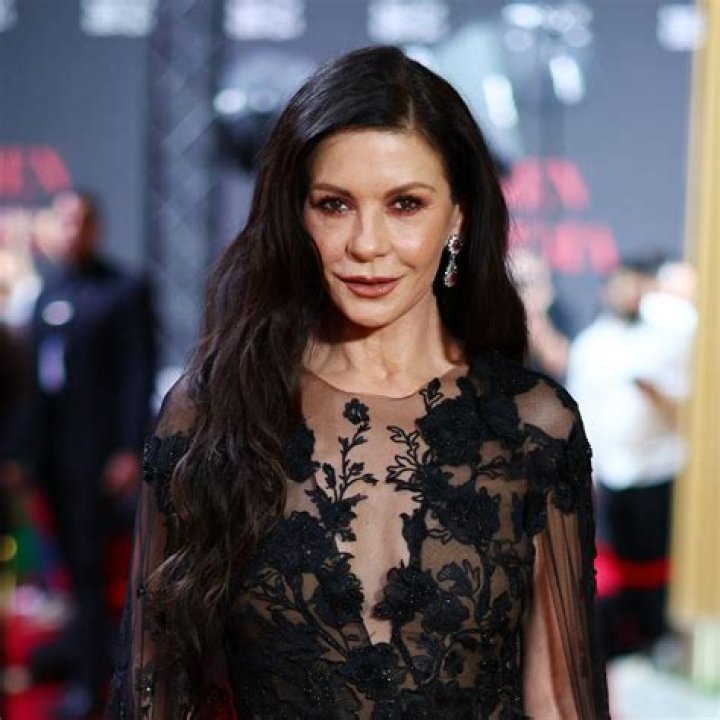 Catherine Zeta-Jones Looks Gorgeous In Black Dress With High Slit At Golden Globes
